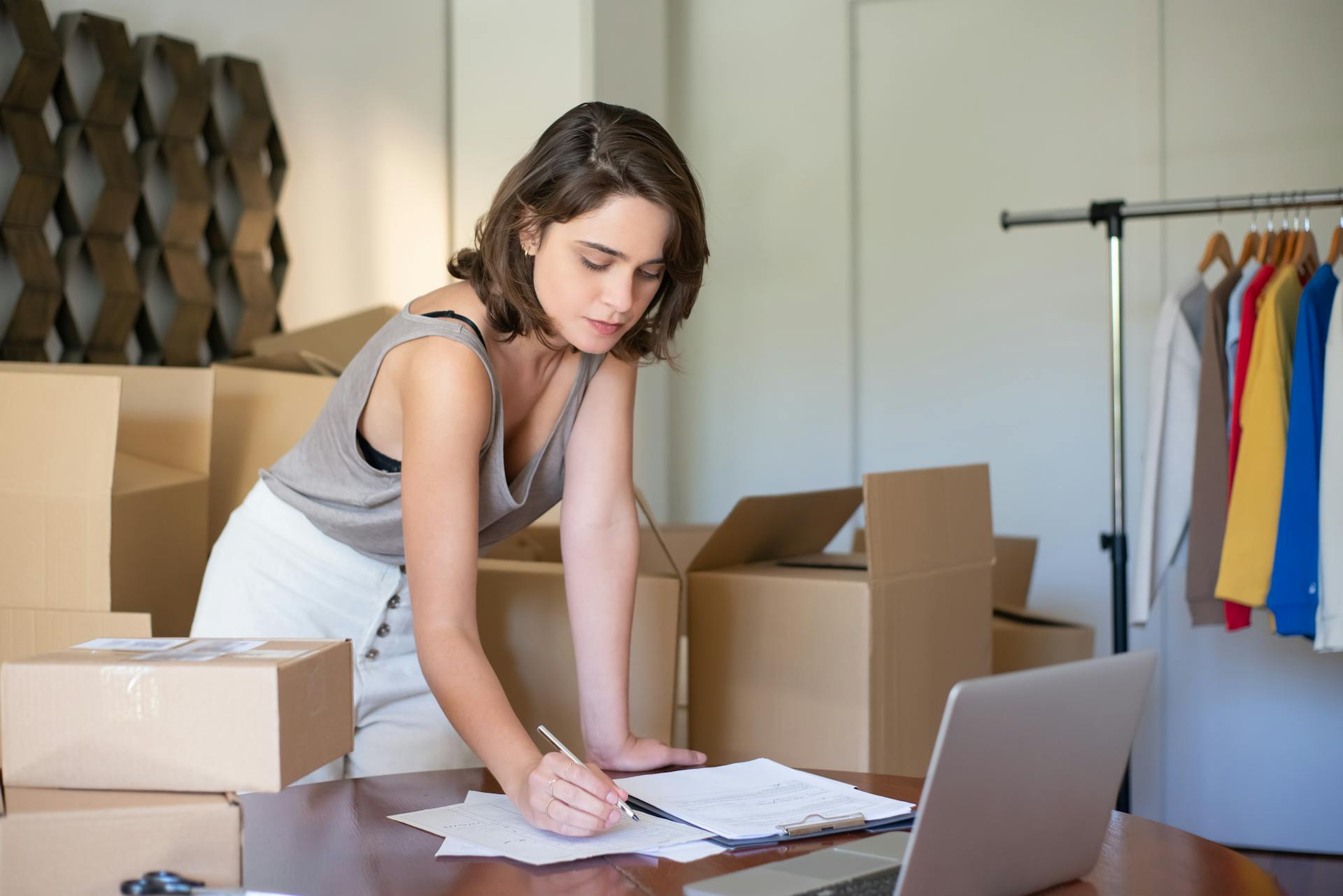 small business owner reviewing CRM dashboard at desk, warm office setting, horizontal orientation